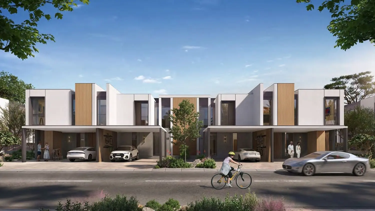 Row of Greenwoods townhouses on a tree-lined street in Dubai Silicon Oasis, with shaded entrances.